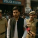 Arjun Mehra escorted by police as supporters protest outside a Gurugram police station